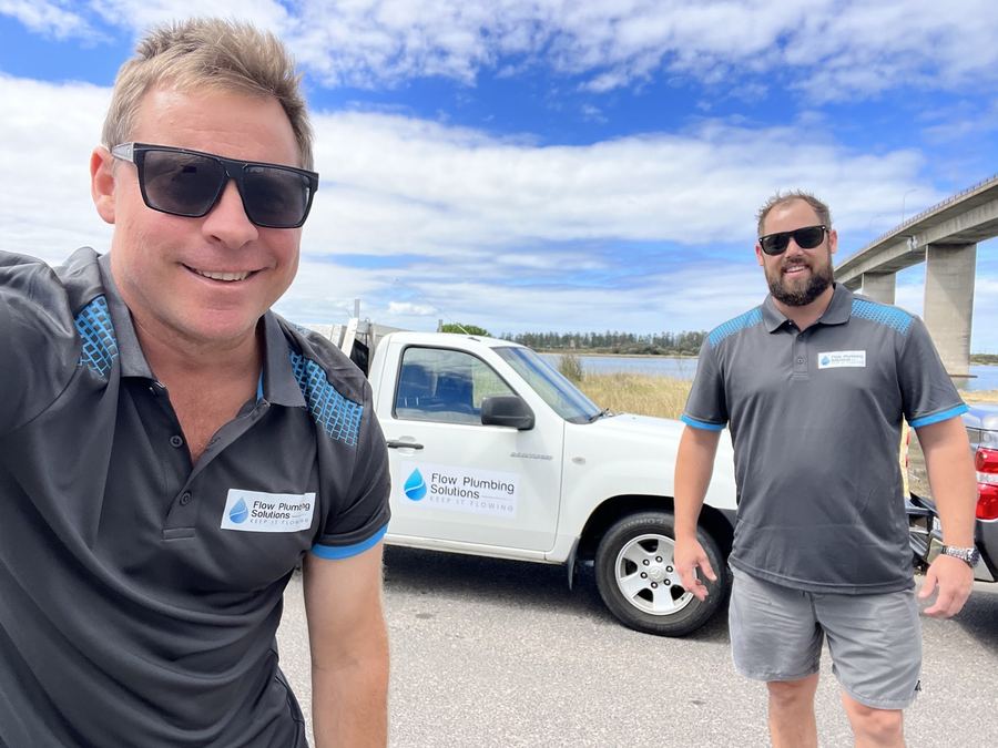 Flow Plumbing Solutions plumbers beside a company ute in Newcastle